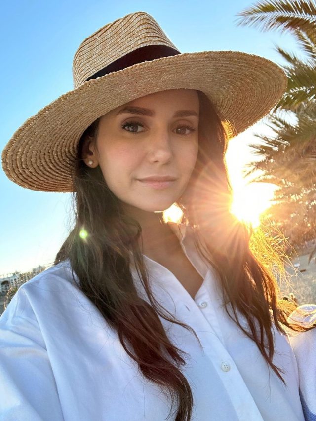 Nina Dobrev Sits Poolside In Black One-Piece Swimsuit and Straw Sunhat in Mexico