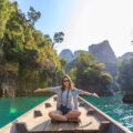 Photo of Woman Sitting on Boat Spreading Her Arms