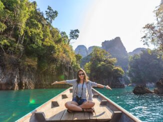 Photo of Woman Sitting on Boat Spreading Her Arms