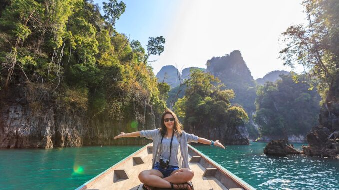 Photo of Woman Sitting on Boat Spreading Her Arms