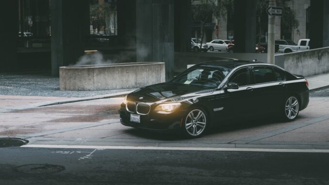 Black Bmw Sedan Beside Concrete Curb