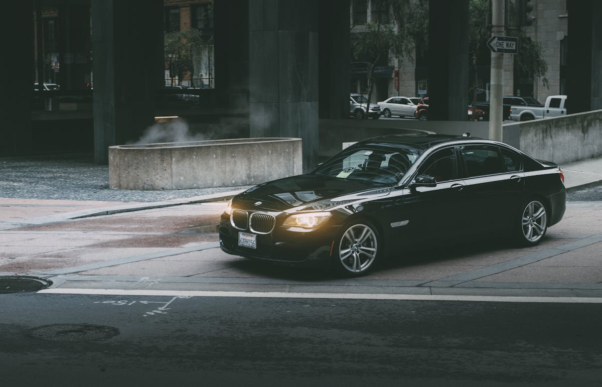 Black Bmw Sedan Beside Concrete Curb