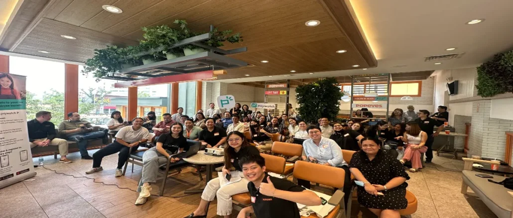 Executives and team members from Paywatch and Popeyes Philippines gathered to celebrate their new partnership, which aims to empower Popeyes employees