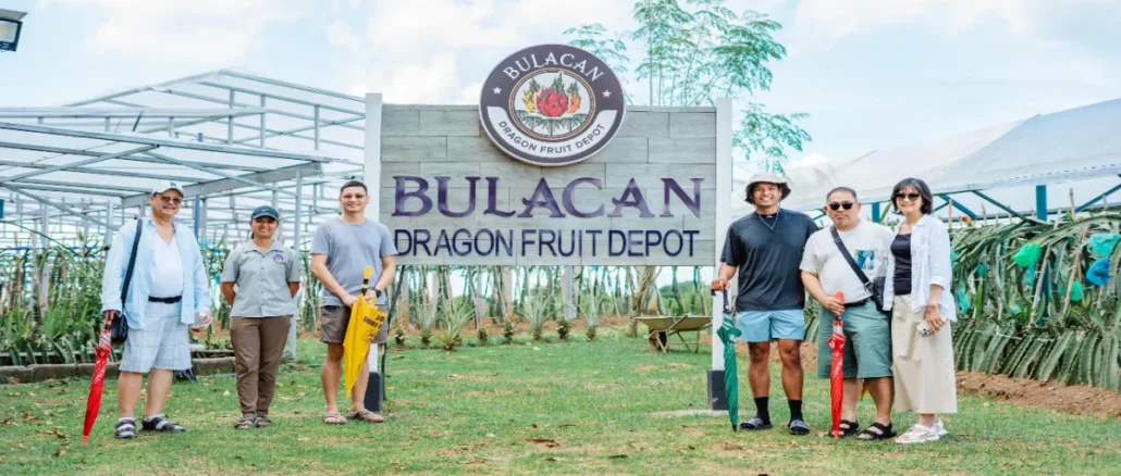 The team behind Bulacan Dragon Fruit Depot, led by Kevin Eliscupides (3rd from right), stands proudly in front of their farm's main entrance.