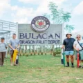 The team behind Bulacan Dragon Fruit Depot, led by Kevin Eliscupides (3rd from right), stands proudly in front of their farm's main entrance.