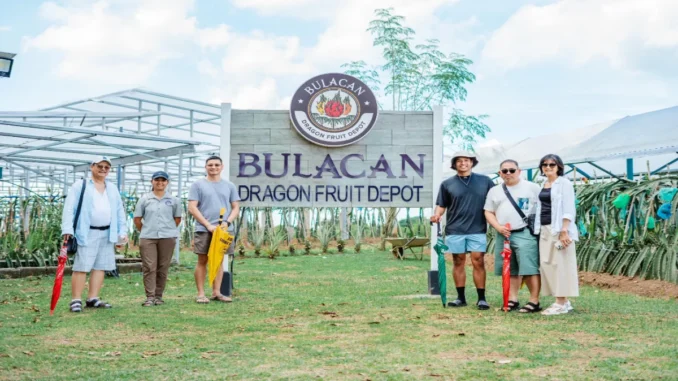 The team behind Bulacan Dragon Fruit Depot, led by Kevin Eliscupides (3rd from right), stands proudly in front of their farm's main entrance.