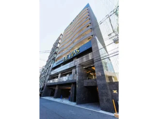 Osaka apartment building with minpaku signage