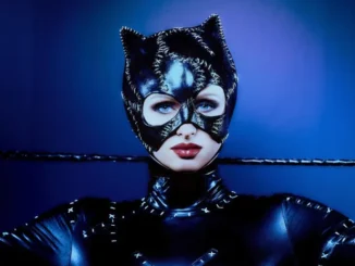 Paris Hilton dressed as Catwoman in a sleek black bodysuit at The Pink Ball 2025, striking a confident pose.
