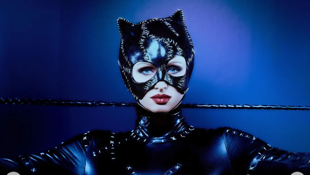 Paris Hilton dressed as Catwoman in a sleek black bodysuit at The Pink Ball 2025, striking a confident pose.