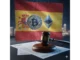 Digital representation of Spanish flag with cryptocurrency symbols and regulatory documents.