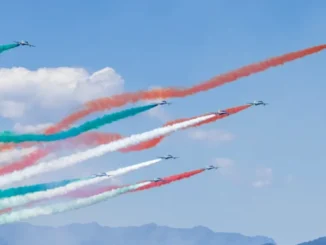 Aerial view of a modern nuclear power plant in India with cooling towers and power lines.
