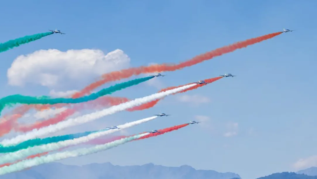 Aerial view of a modern nuclear power plant in India with cooling towers and power lines.