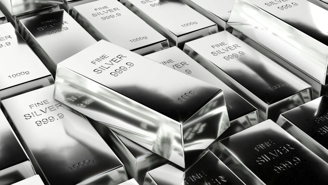 Shimmering silver bars and coins against a map of India showing key cities.