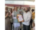 MLA Prasad Abbayya distributing title deeds to residents in Hubballi.