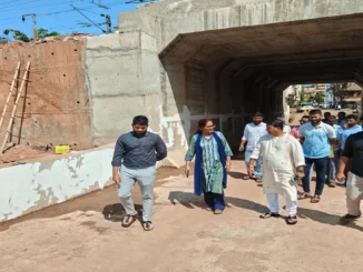 DRM Bela Meena and MLA Krishna Salkar reviewing the railway underbridge blueprints at the Vasco construction site.