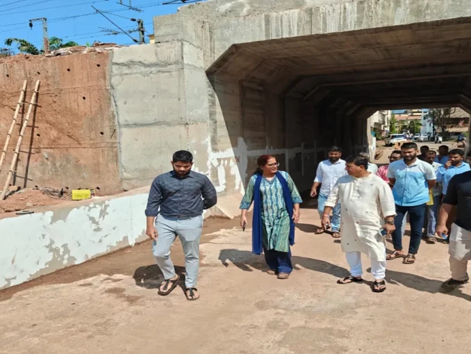 DRM Bela Meena and MLA Krishna Salkar reviewing the railway underbridge blueprints at the Vasco construction site.