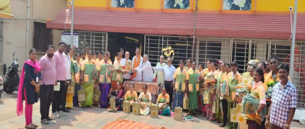 Shri Shivu Menasinakai distributing food kits and uniforms to municipal workers in Dharwad.
