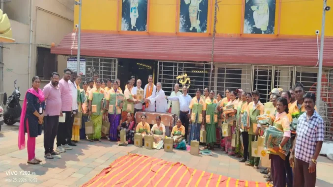 Shri Shivu Menasinakai distributing food kits and uniforms to municipal workers in Dharwad.