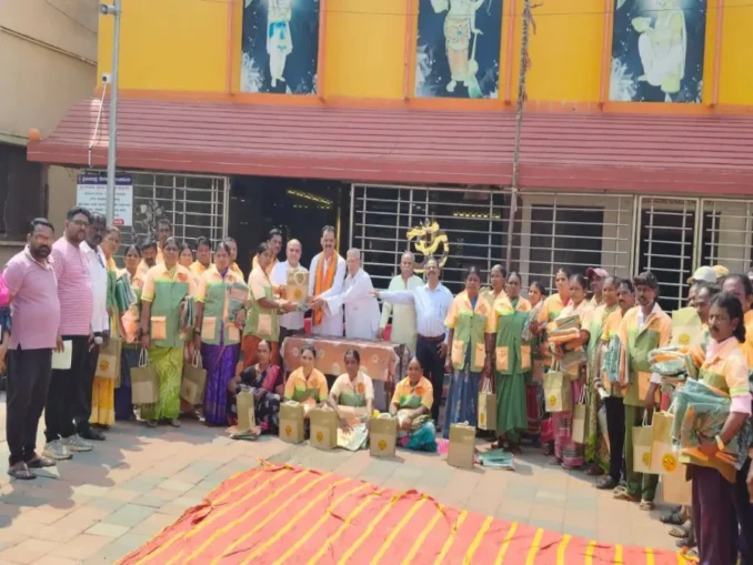 Shri Shivu Menasinakai distributing food kits and uniforms to municipal workers in Dharwad.