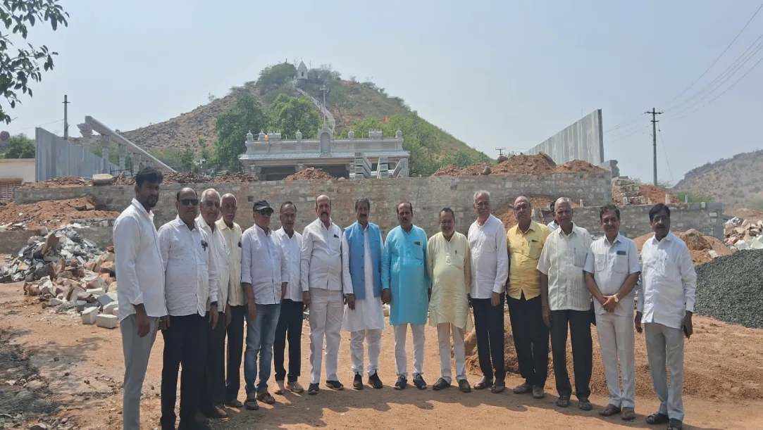 Satish Meharwade and temple committee members inspecting stone carvings in Badami.