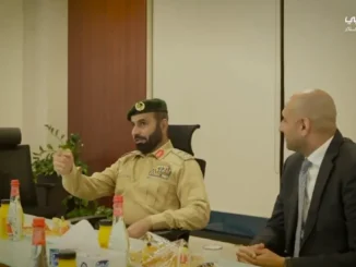 Dubai Police VOYAH FREE electric patrol vehicle parked in front of Dubai skyline.