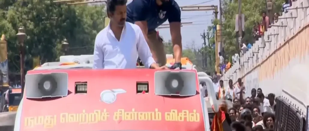 Thalapathy Vijay getting out of his car to help a couple who fell from a motorcycle.