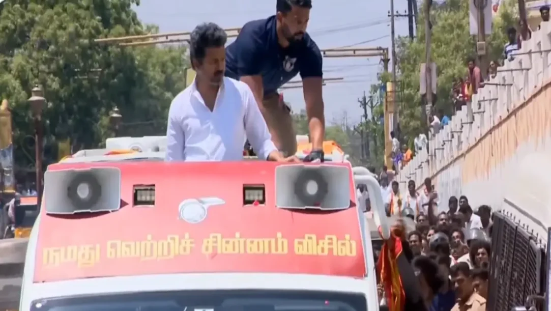 Thalapathy Vijay getting out of his car to help a couple who fell from a motorcycle.