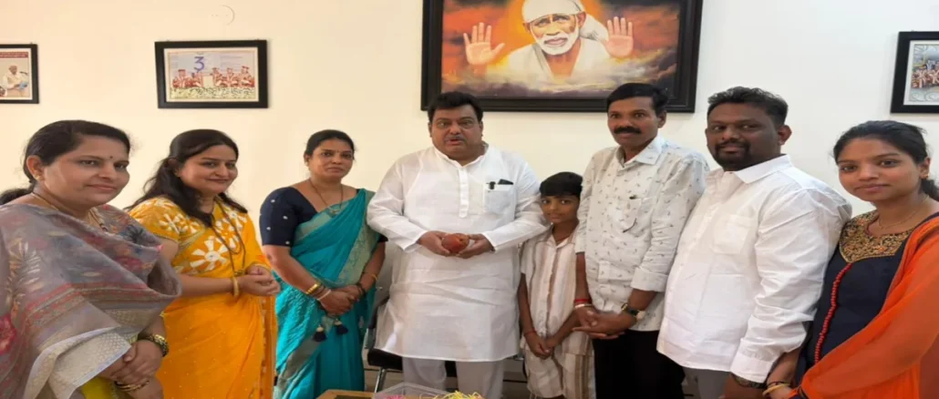 Rajashree Anant Jain standing with her Miyazaki mango trees in Indi, Vijayapura.