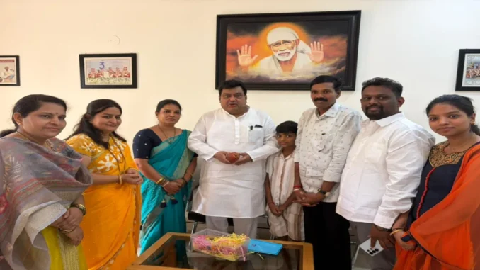 Rajashree Anant Jain standing with her Miyazaki mango trees in Indi, Vijayapura.