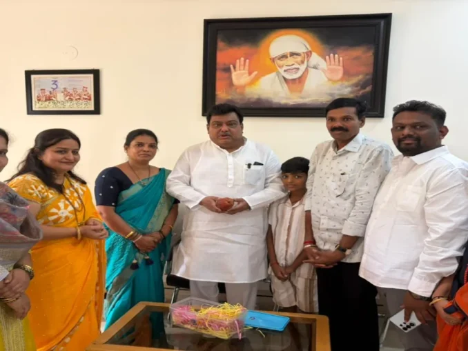 Rajashree Anant Jain standing with her Miyazaki mango trees in Indi, Vijayapura.