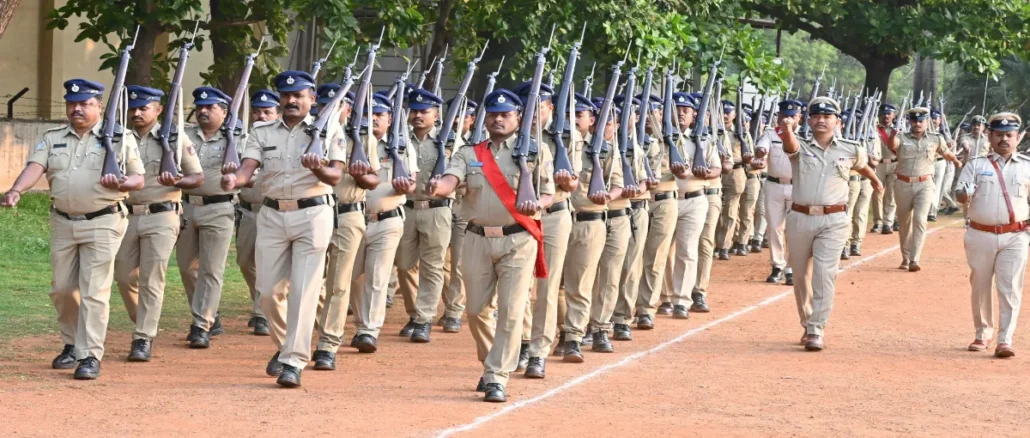 Police Commissioner N Shashi Kumar IPS receiving salute during weekly parade at Hubballi Old CAR grounds with DCP Shruti NS and DCP Ravish CR.