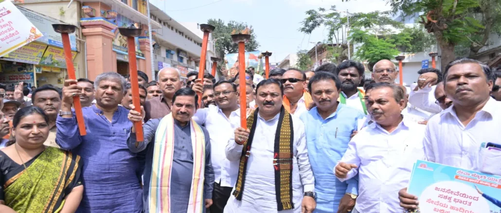 Pralhad Joshi leading the Hubballi Seva Jyoti Yatra for 25 years of Narendra Modi’s public service
