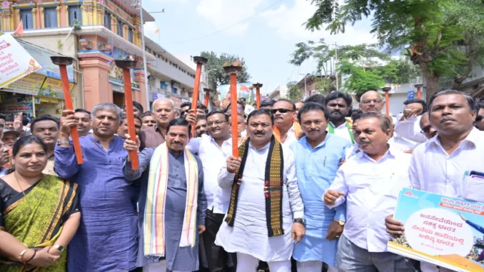 Pralhad Joshi leading the Hubballi Seva Jyoti Yatra for 25 years of Narendra Modi’s public service