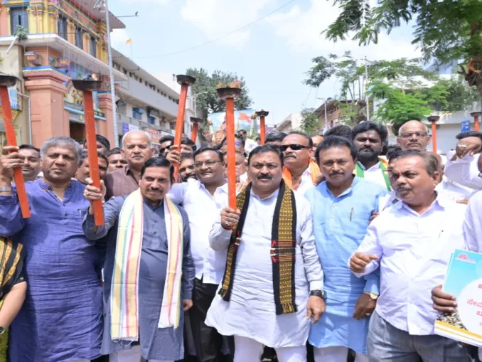 Pralhad Joshi leading the Hubballi Seva Jyoti Yatra for 25 years of Narendra Modi’s public service